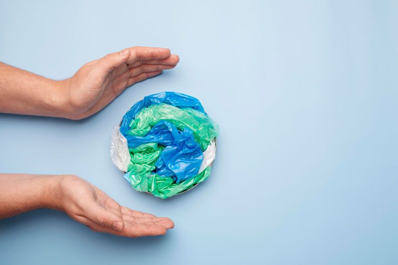Hands holding a plastic-shaped earth